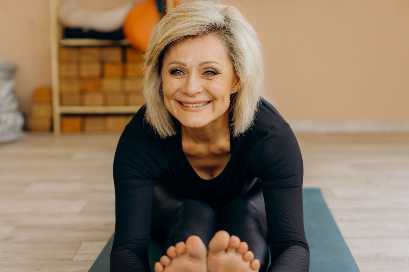 Smiling woman in her 50s doing yoga